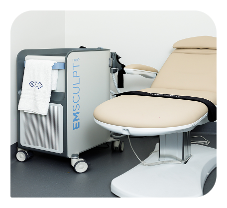 EMSCULPT NEO device beside a treatment chair.