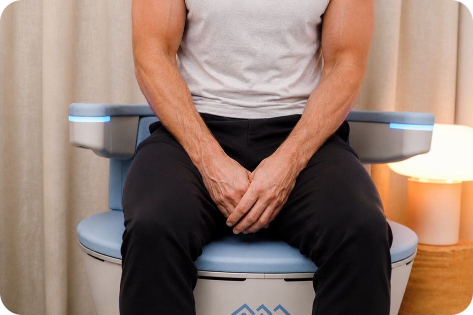 Man in everyday clothing seated on the EMSELLA treatment chair.